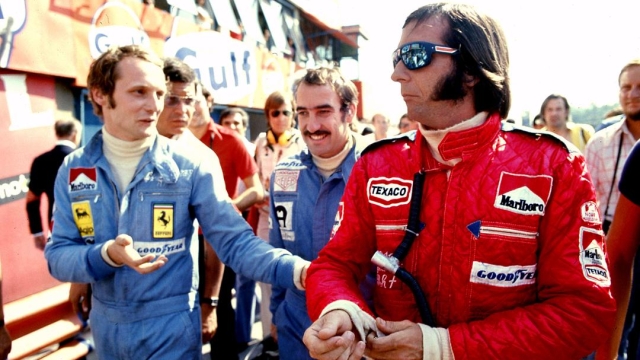 Fittipaldi, in rosso, parla con Lauda prima del GP; alle loro spalle Regazzoni. Lapresse