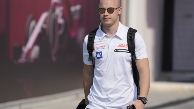 FILE - Haas driver Nikita Mazepin of Russia arrives to the Losail International Circuit in Losail, Qatar, Thursday, Nov. 18, 2021 ahead of the Qatar Formula One Grand Prix. Auto racing's international body, the FIA, said Russian drivers like Nikita Mazepin can still compete but a block on having cars in national colors would stop Mazepin's team Haas bringing back the Russian flag-stripe livery it removed during last week's testing. The Russian Grand Prix was cut from the calendar on Friday. (AP Photo/Darko Bandic, File)