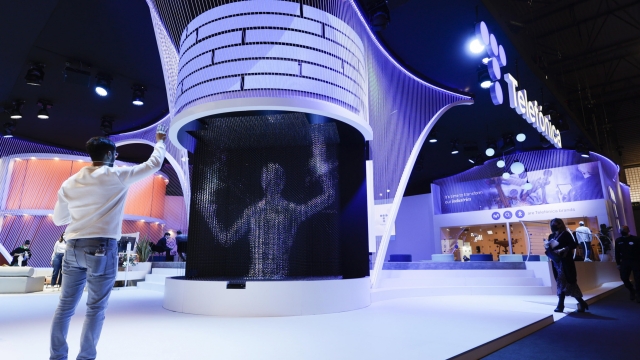 epa09798735 A visitor interacts with a hologram at Telefonica exhibitor at Mobile World Congress (MWC), in Barcelona, northeastern Spain, 03 March 2022. The Mobile World Congress, running from 28 February to 03 March 2022, is the largest technology fair in the world.  EPA/QUIQUE GARCIA