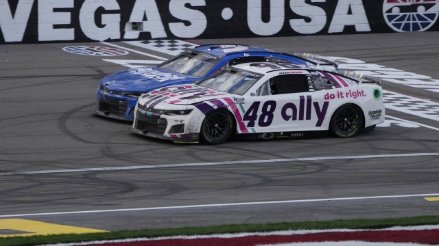 Alex Bowman (48) races beside Kyle Larson (5) during a NASCAR Cup Series auto race Sunday, March 6, 2022, in Las Vegas. (AP Photo/John Locher)