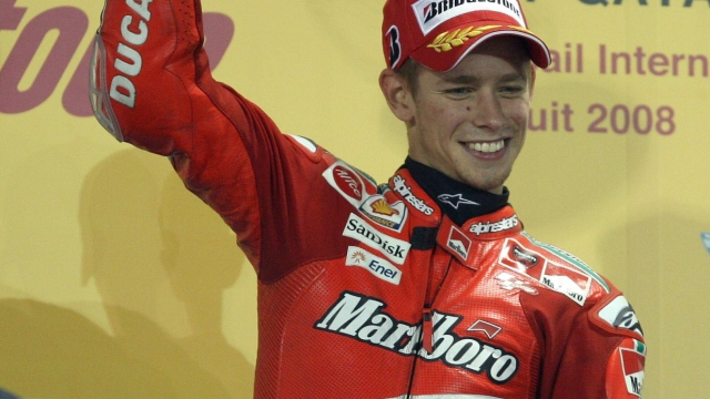 Australian rider Casey Stoner raises his trophy on the podium after winning the moto GP event at the Qatar Grand Prix in Doha on March 9, 2007. Defending world champion Casey Stoner of Australia, on a Ducati, won the season-opening Qatar Grand Prix here on Sunday, the first world championship race to be held at night. AFP PHOTO/KARIM JAAFAR