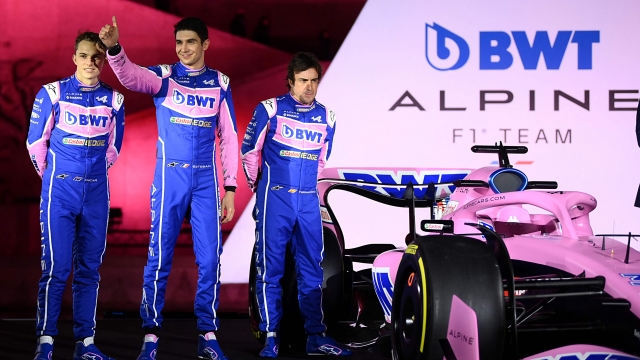 (From L) Alpine F1 team's drivers, Australian Oscar Piastri, French Esteban Ocon and Spanish Fernando Alonso, pose during the unveiling of Alpine F1 team's A522 new racing car for the upcoming Formula One 2022 season at the Palais de Tokyo in Paris on February 21, 2022, two days before the first pre-season track session of the year at the Circuit de Barcelona-Catalunya. - The A522 will be raced this year by Fernando Alonso and Esteban Ocon, wholl team up for a second season at Alpine. (Photo by FRANCK FIFE / AFP)