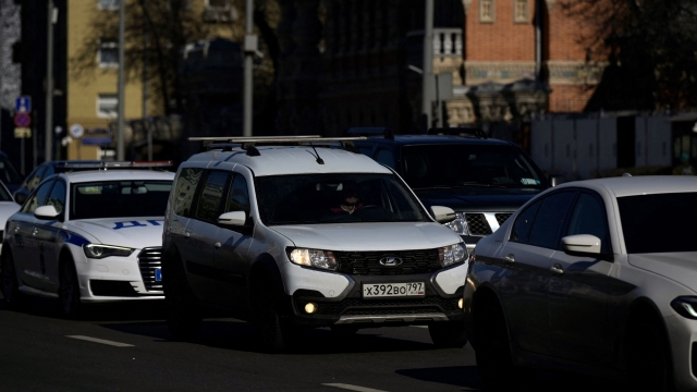 Cars, including a Russian-made Lada (C), move on a street in Moscow on March 10, 2022. (Photo by AFP)