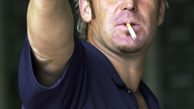 FILE - Australia's Shane Warne gestures during the fifth day of the second cricket test match between India and Australia in Madras, India, Monday, Oct. 18, 2004. The second cricket test between India and Australia ended in a draw Monday as rain-washed out the entire last days play. Shane Warne, one of the greatest cricket players in history, has died. He was 52. Fox Sports television, which employed Warne as a commentator, quoted a family statement as saying he died of a suspected heart attack in Koh Samui, Thailand. (AP Photo/M. Lakshman, File)