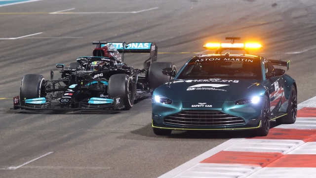 Mercedes' British driver Lewis Hamilton drives behind the safety car at the Yas Marina Circuit during the Abu Dhabi Formula One Grand Prix on December 12, 2021. (Photo by Giuseppe CACACE / AFP)