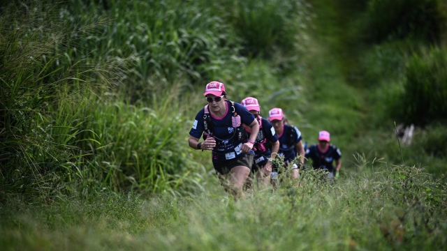 Participants compete in an orienteering race in Saint Pierre as part of the "Raid des Alizes" exclusively all-female multi sport competition in the French Caribbean island of Martinique on November 27, 2021. - Each team represent a charity project of their choice during the competition. According to the final ranking, donations will be directly processed in favor of the represented associations. (Photo by Anne-Christine POUJOULAT / AFP)