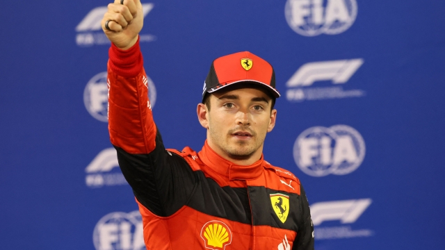 Ferrari's Monegasque driver Charles Leclerc reacts after taking pole position in  the qualifying session on the eve of the Bahrain Formula One Grand Prix at the Bahrain International Circuit in the city of Sakhir on March 19, 2022. (Photo by Giuseppe CACACE / POOL / AFP)