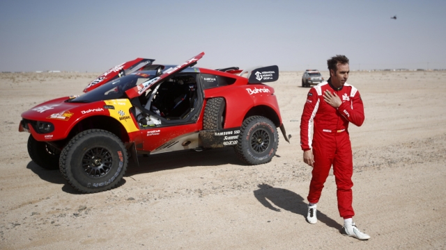 epa09676258 Spanish driver Nani Roma of Bahrain Raid Xtreme team gestures during the neutral zone of the stage 7 of the Rally Dakar 2022 between Riyadh and Riyadh, in Saudi Arabia, 09 January 2022.  EPA/YOAN VALAT