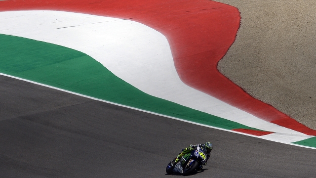 (FILES) In this file photo taken on May 31, 2015 Italy's Valentino Rossi races during the Italian MotoGP Grand Prix at the Mugello racetrack. - Moto legend and seven time top-level world champion Valentino Rossi confirmed on August 5, 2021 he will retire at the end of the year after 26 years lighting up the sport. The 42-year-old Italian signed a one-season deal with Yamaha-SRT for this campaign and it had been mooted he might ride for his own team next term, but he told a press conference ahead of this weekend's Styrian Grand Prix that he will call it a day, 12 years on from his last MotoGP title. (Photo by Filippo MONTEFORTE / AFP)