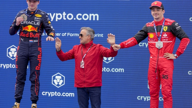 Former driver Jean Alesi, center, poses with first placed Red Bull driver Max Verstappen of the Netherlands, left, and second placed Ferrari driver Charles Leclerc of Monaco on the podium of a sprint race at the Enzo and Dino Ferrari racetrack, in Imola, Italy, Saturday, April 23, 2022. The Italy's Emilia Romagna Formula One Grand Prix will be held on Sunday. (AP Photo/Luca Bruno)