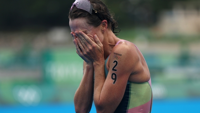 TOKYO, JAPAN - JULY 27:  Gold medalist Flora Duffy of Team Bermuda reacts after crossing the finish line during the Women's Individual Triathlon on day four of the Tokyo 2020 Olympic Games at Odaiba Marine Park on July 27, 2021 in Tokyo, Japan. (Photo by Buda Mendes/Getty Images)