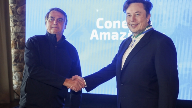 In this handout photo provided by the Ministry of Communication, Brazil's President Jair Bolsonaro, left, and Tesla and SpaceX chief executive officer Elon Musk shake hands during a meeting in Porto Feliz, Brazil, Friday, May 20, 2022. Musk met with Bolsonaro on Friday to discuss connectivity and other projects in the Amazon rainforest. (Cleverson Oliveira/Ministry of Communication via AP)