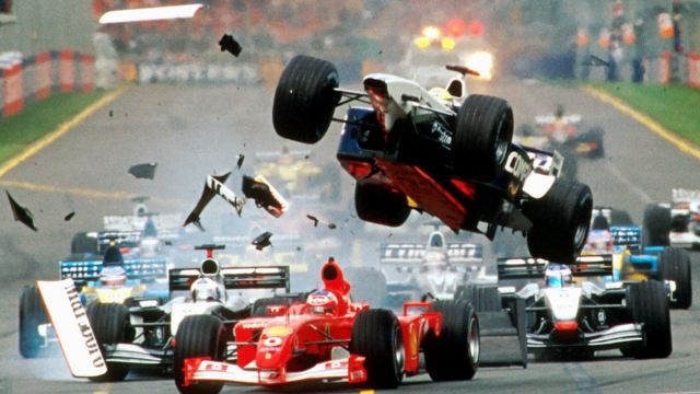 ** FILE ** The Williams of Ralf Schumacher of Germany, center, flies over the Ferrari of Brazil's Rubens Barrichello as they collide while heading for the first corner of the first lap of the Australian Formula One Grand Prix in Melbourne, in this March 3, 2002 file photo. The creditor banks of financial troubled German Kirch Group's Formula One investment are planning to either sell the business outright once they seize it or float it in an initial public offering. Kirch Group, which in 2001 borrowed about dlrs 1.6 billion (euros 1.8 billion) to finance the purchase  of its 58.3 percent stake in Formula One's marketing arm, SLEC holding, has already defaulted on the loan, allowing the banks to take possession of the stake. (AP Photo/Australian Grand Prix Corp., Joe Mann)