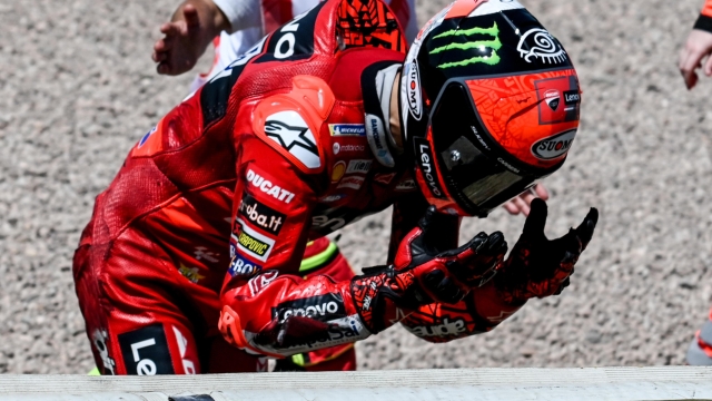 epa10022214 Italian MotoGP rider Francesco Bagnaia of Ducati Lenovo Team reacts after crashing during the MotoGP race of the Motorcycling Grand Prix of Germany at the Sachsenring racing circuit in Hohenstein-Ernstthal, Germany, 19 June 2022.  EPA/FILIP SINGER