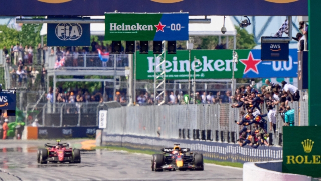 Red Bull Racing's Dutch driver Max Verstappen takes the checkered flag to win the Canada Formula 1 Grand Prix on June 19, 2022, at Circuit Gilles-Villeneuve in Montreal. (Photo by Geoff Robins / AFP)