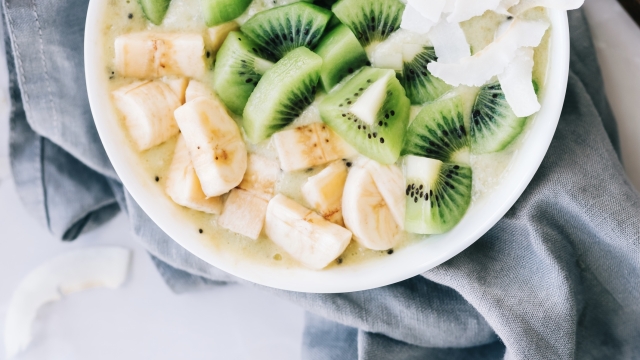 Healthy fruit smoothie bowl with banana, coconut and kiwi.