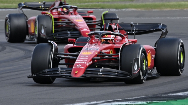 Ferrari's Monegasque driver Charles Leclerc (R) leads Ferrari's Spanish driver Carlos Sainz Jr during the Formula One British Grand Prix at the Silverstone motor racing circuit in Silverstone, central England on July 3, 2022. (Photo by JUSTIN TALLIS / AFP)