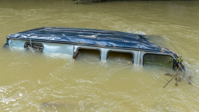 A vehicle is submerged in Troublesome Creek near Dwarf, Ky., on Tuesday, Aug. 2, 2022. (Ryan C. Hermens/Lexington Herald-Leader via AP)