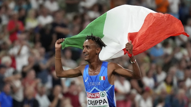 Yemaneberhan Crippa, of Italy, celebrates after winning the bronze medal in the Men's 5000 meters during the athletics competition in the Olympic Stadium at the European Championships in Munich, Germany, Tuesday, Aug. 16, 2022. (AP Photo/Matthias Schrader)