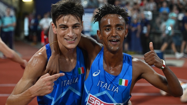 epa10132594 Yemaneberhan Crippa (R) of Italy celebrates winning the men's 10,000m gold medal with Pietro Riva (L)  at the European Championships Munich 2022, Munich, Germany, 21 August 2022. The championships will feature nine Olympic sports, Athletics, Beach Volleyball, Canoe Sprint, Cycling, Artistic Gymnastics, Rowing, Sport Climbing, Table Tennis and Triathlon.  EPA/CHRISTIAN BRUNA