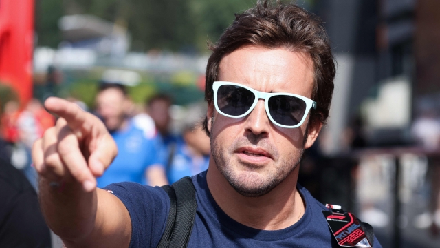 Alpine's Spanish driver Fernando Alonso gestures as he walks to the Paddock ahead of the Spa-Francorchamps racetrack on August 25, 2022. - The Formula One Belgian Grand Prix will take place on August 28, 2022. (Photo by Kenzo TRIBOUILLARD / AFP)