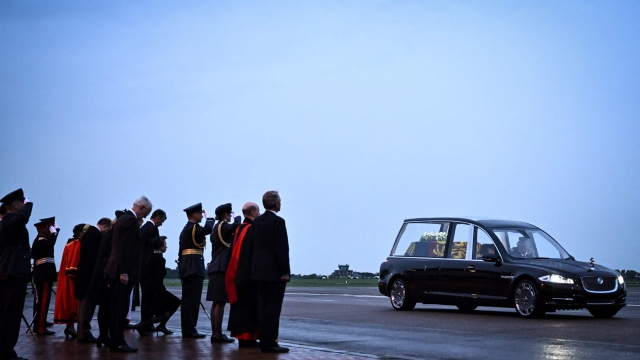 TOPSHOT - Britain's Princess Anne, Princess Royal, and other dignitaries salute as the coffin of Queen Elizabeth II is taken away in the Royal Hearse from the Royal Air Force Northolt airbase on September 13, 2022, to travel to Buckingham Palace. - Mourners in Edinburgh filed past the coffin of Queen Elizabeth II through the night, before the monarch's coffin returns to London to Lie in State ahead of her funeral on September 19. (Photo by Ben Stansall / POOL / AFP)