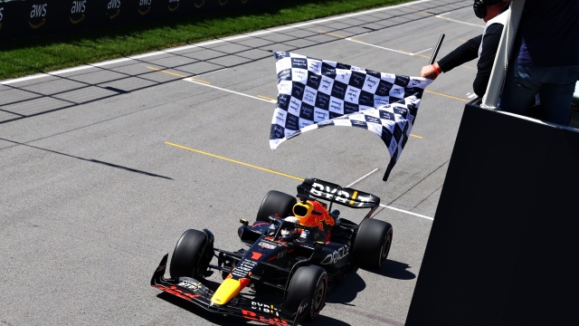 MONTREAL, QUEBEC - JUNE 19: Race winner Max Verstappen of the Netherlands driving the (1) Oracle Red Bull Racing RB18 takes the chequered flag during the F1 Grand Prix of Canada at Circuit Gilles Villeneuve on June 19, 2022 in Montreal, Quebec.   Clive Rose/Getty Images/AFP
== FOR NEWSPAPERS, INTERNET, TELCOS & TELEVISION USE ONLY ==