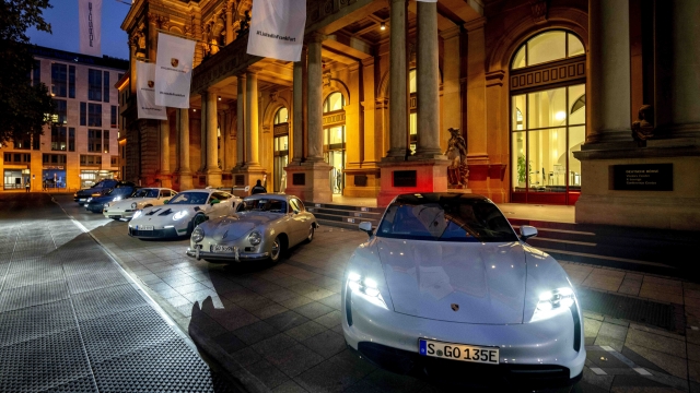 Porsche cars are lined up in front of the stock market at the start of Porsche's market listing in Frankfurt, Germany, Thursday, Sept. 29, 2022. (AP Photo/Michael Probst)