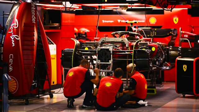SINGAPORE, SINGAPORE - SEPTEMBER 29: The Ferrari team work in the garage during previews ahead of the F1 Grand Prix of Singapore at Marina Bay Street Circuit on September 29, 2022 in Singapore, Singapore. (Photo by Clive Mason/Getty Images,)