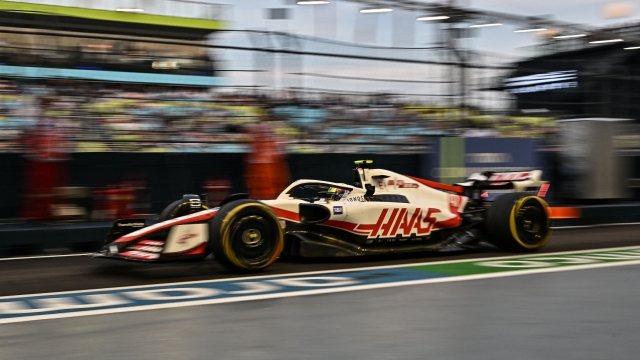 Haas F1 Team's German driver Mick Schumacher drives in the pit lane during the first practice session ahead of the Formula One Singapore Grand Prix night race at the Marina Bay Street Circuit in Singapore on September 30, 2022. (Photo by Lillian SUWANRUMPHA / AFP)