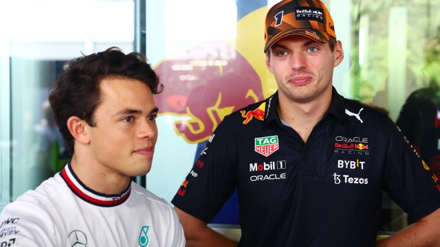 SINGAPORE, SINGAPORE - OCTOBER 02: Max Verstappen of the Netherlands and Oracle Red Bull Racing and Nyck de Vries of Netherlands, Mercedes Test and Reserve Driver talk in the Paddock prior to the F1 Grand Prix of Singapore at Marina Bay Street Circuit on October 02, 2022 in Singapore, Singapore. (Photo by Mark Thompson/Getty Images,)