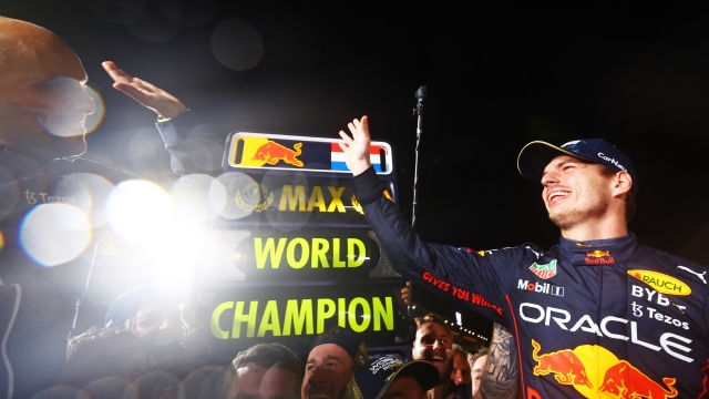 SUZUKA, JAPAN - OCTOBER 09: Race winner and 2022 F1 World Drivers Champion Max Verstappen of Netherlands and Oracle Red Bull Racing celebrates with his team after the F1 Grand Prix of Japan at Suzuka International Racing Course on October 09, 2022 in Suzuka, Japan. (Photo by Mark Thompson/Getty Images )