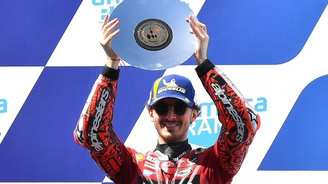 Third placed Ducati Lenovo's Italian rider Francesco Bagnaia celebrates on the podium after the MotoGP Australian Grand Prix at Phillip Island on October 16, 2022. (Photo by Paul CROCK / AFP) / -- IMAGE RESTRICTED TO EDITORIAL USE - STRICTLY NO COMMERCIAL USE --