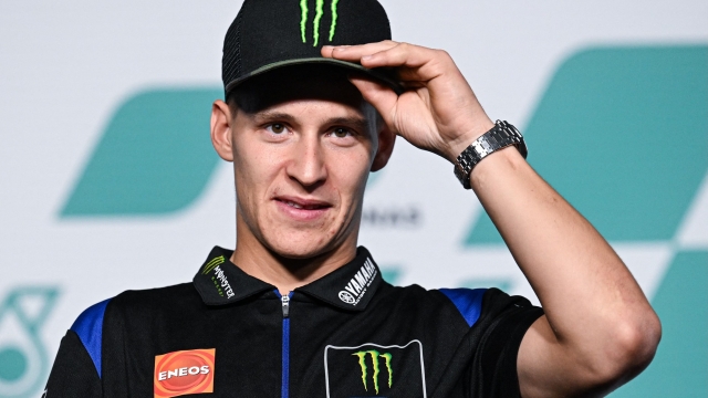 Monster Energy Yamaha MotoGP's French rider Fabio Quartararo adjusts his cap during a press conference at the Sepang International Circuit in Sepang on October 20, 2022, ahead of the practice sessions for the MotoGP Malaysia Grand Prix. (Photo by Mohd RASFAN / AFP)