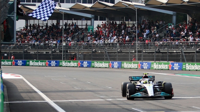 The checkered flag is waved for Mercedes' British driver Lewis Hamilton at the end the Formula One Mexico Grand Prix at the Hermanos Rodriguez racetrack in Mexico City on October 30, 2022. (Photo by CARLOS PEREZ GALLARDO / POOL / AFP)