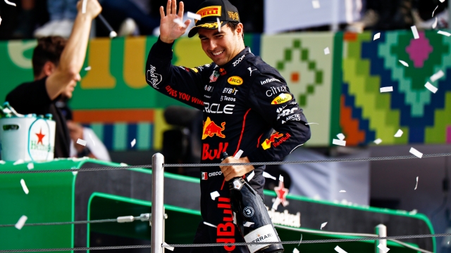 MEXICO CITY, MEXICO - OCTOBER 30: Third placed Sergio Perez of Mexico and Oracle Red Bull Racing celebrates on the podium during the F1 Grand Prix of Mexico at Autodromo Hermanos Rodriguez on October 30, 2022 in Mexico City, Mexico. (Photo by Clive Mason - Formula 1/Formula 1 via Getty Images)