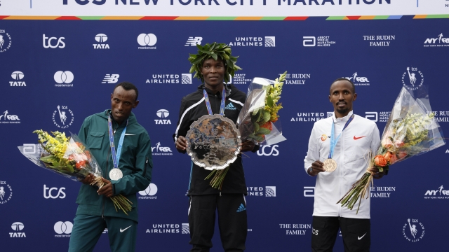 From left, men's division second place finisher Shura Kitata, of Ethiopia, winner Evans Chebet, of Kenya, and third place finisher Abdi Nageeye, of the Netherlands, pose during a ceremony at the finish line of the New York City Marathon, Sunday, Nov. 6, 2022, in New York. (AP Photo/Jason DeCrow)