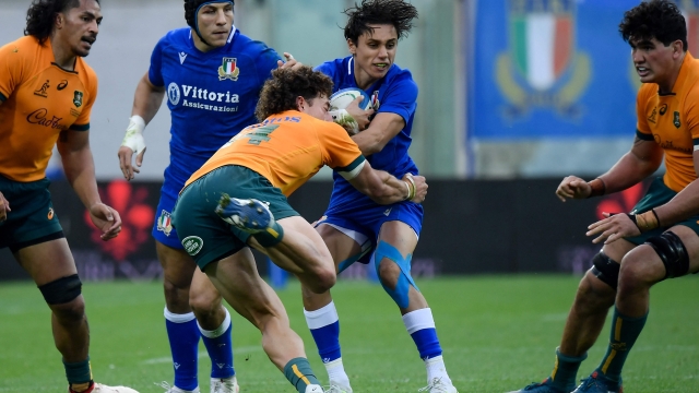 Australia's wing Mark Nawaqanitawase (Front L) tackles Italy's full back Ange Capuozzo during the rugby union Test match between Italy and Australia on November 12, 2022 at the Artemio-Franchi stadium in Florence, Tuscany. (Photo by Filippo MONTEFORTE / AFP)