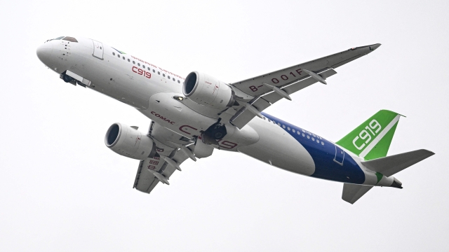 (FILES) This file photo taken on November 8, 2022 shows a Commercial Aircraft Corp of China (COMAC) C919 aircraft, China's first domestically produced large passenger jet, performing during the Airshow China 2022 in Zhuhai, in southern China's Guangdong province. - China announced on November 9, 2022, hundreds of new orders for its first domestically manufactured large passenger jet, with the aircraft poised to make its commercial debut early next year. (Photo by CNS / AFP) / China OUT