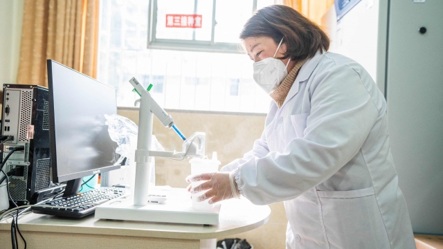 This photo taken on December 29, 2022 shows a health worker preparing a dose of CanSino Biologics inhalable Covid-19 coronavirus vaccine in Bijie, in China's southwestern Guizhou province. (Photo by AFP) / China OUT