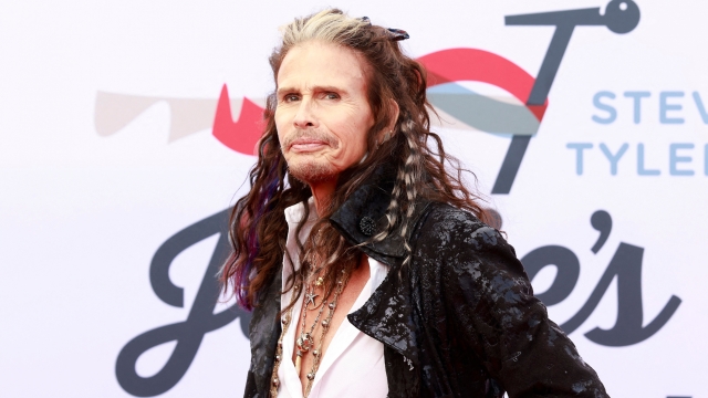 (FILES) In this file photo taken on April 3, 2022, US singer-songwriter Steven Tyler arrives for his 4th Annual Grammy Awards Viewing Party at the Hollywood Palladium in Los Angeles. - Aerosmith frontman Steven Tyler is facing a lawsuit by a woman who claims he sexually assaulted her as a minor during a years-long relationship in the 1970s. Claimant Julia Holcomb, who is now 65, alleges "American Idol" judge Tyler was granted guardianship of her when she was 16, which he used to engage in a sexual relationship. (Photo by Michael Tran / AFP)
