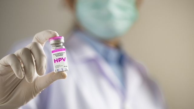 HPV (Human Papillomavirus) Doctor or scientist holding liquid vaccines HPV vaccine.viruses Some strains infect genitals and can cause cervical cancer.
