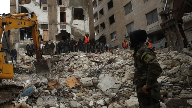 Civil defense workers and security forces search through the wreckage of collapsed buildings in Hama, Syria, Monday, Feb. 6, 2023. A powerful earthquake has caused significant damage in southeast Turkey and Syria and many casualties are feared. Damage was reported across several Turkish provinces, and rescue teams were being sent from around the country. (AP Photo/Omar Sanadiki)