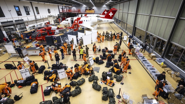 Swiss experts and rescuers with service dogs prepare to fly to the earthquake-hit Turkey, at Zurich Airport, Switzerland, Monday Feb. 6, 2023. A powerful quake has knocked down multiple buildings in southeast Turkey and Syria and many casualties are feared. (Michael Buholzer/Keystone via AP)