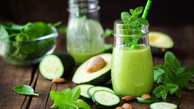 Green detox smoothie with avocado, cucumber, spinach and with fresh mint. Healthy eating, weight loss and dieting concept