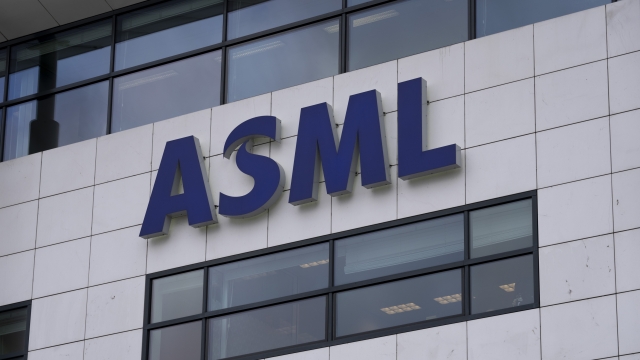FILE - the logo of ASML, a leading maker of semiconductor production equipment, hangs on the head office in Veldhoven, Netherlands, Monday, Jan. 30, 2023. The Dutch government announced Tuesday that it is planning on imposing additional restrictions on the export of machines that make advanced processor chips, joining a U.S. initiative that aims at restricting China's access to materials used to make such chips. Dutch Minister for Foreign Trade and Development Cooperation Liesje Schreinemacher sent a letter to lawmakers outlining the proposed limitations, which come in addition to existing export controls on semiconductor technology.  (AP Photo/Peter Dejong, File)
