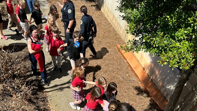 Children from The Covenant School, a private Christian school in Nashville, Tenn., hold hands as they are taken to a reunification site at the Woodmont Baptist Church after a shooting at their school, on Monday, March, 27, 2023. (George Uribe via AP)