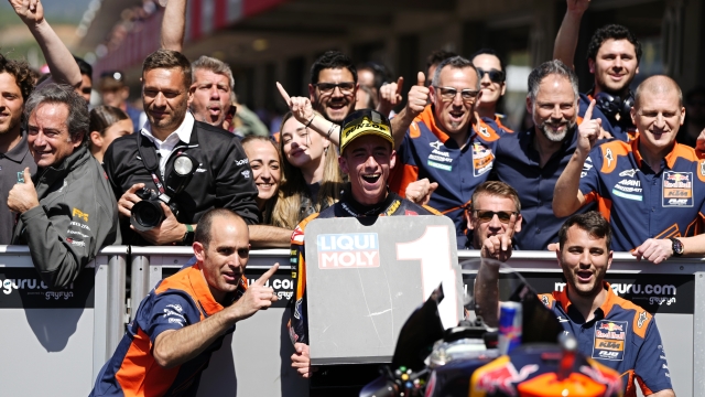 Moto2 rider Pedro Acosta of Spain poses with his team after winning the Portugal Motorcycle Grand Prix, at the Algarve International circuit near Portimao, Portugal, Sunday, March 26, 2023. (AP Photo/Jose Breton)