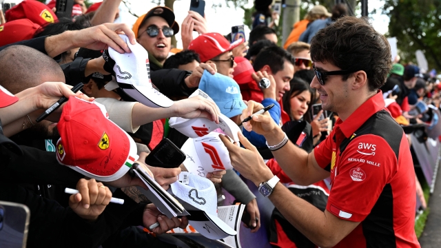 Ferrari's Monegasque driver Charles Leclerc signs autographs to fans ahead of the third practice session of the 2023 Formula One Australian Grand Prix at the Albert Park Circuit in Melbourne on April 1, 2023. (Photo by WILLIAM WEST / AFP) / -- IMAGE RESTRICTED TO EDITORIAL USE - STRICTLY NO COMMERCIAL USE --