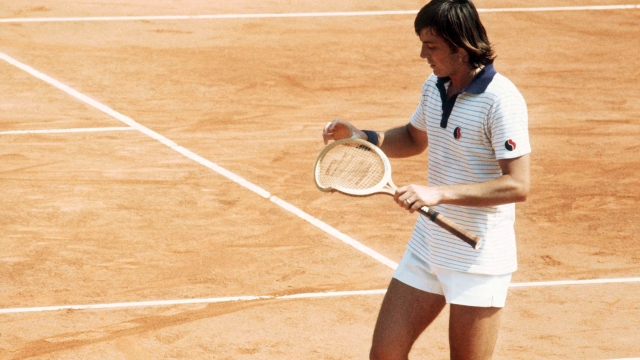 Italian tennis player Adriano Panatta looks at his broken racquet in his match against Mexican Raul Ramirez in june 1977 during the French Open at Roland Garros stadium. (Photo by - / AFP) (Photo by -/AFP via Getty Images)